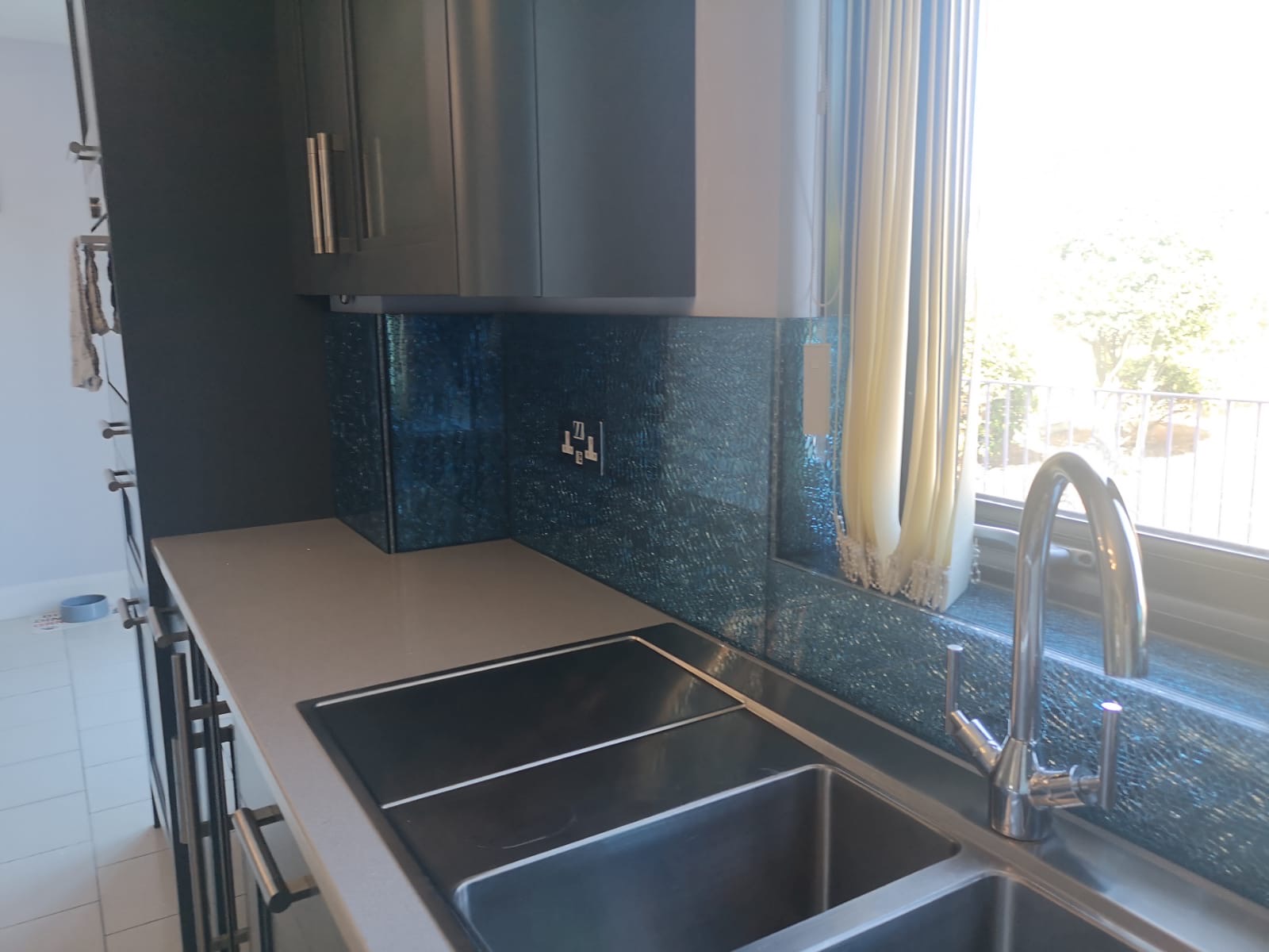 Kitchen blue glass mosaic splashback sink, made and fitted by Sussex Design Interiors