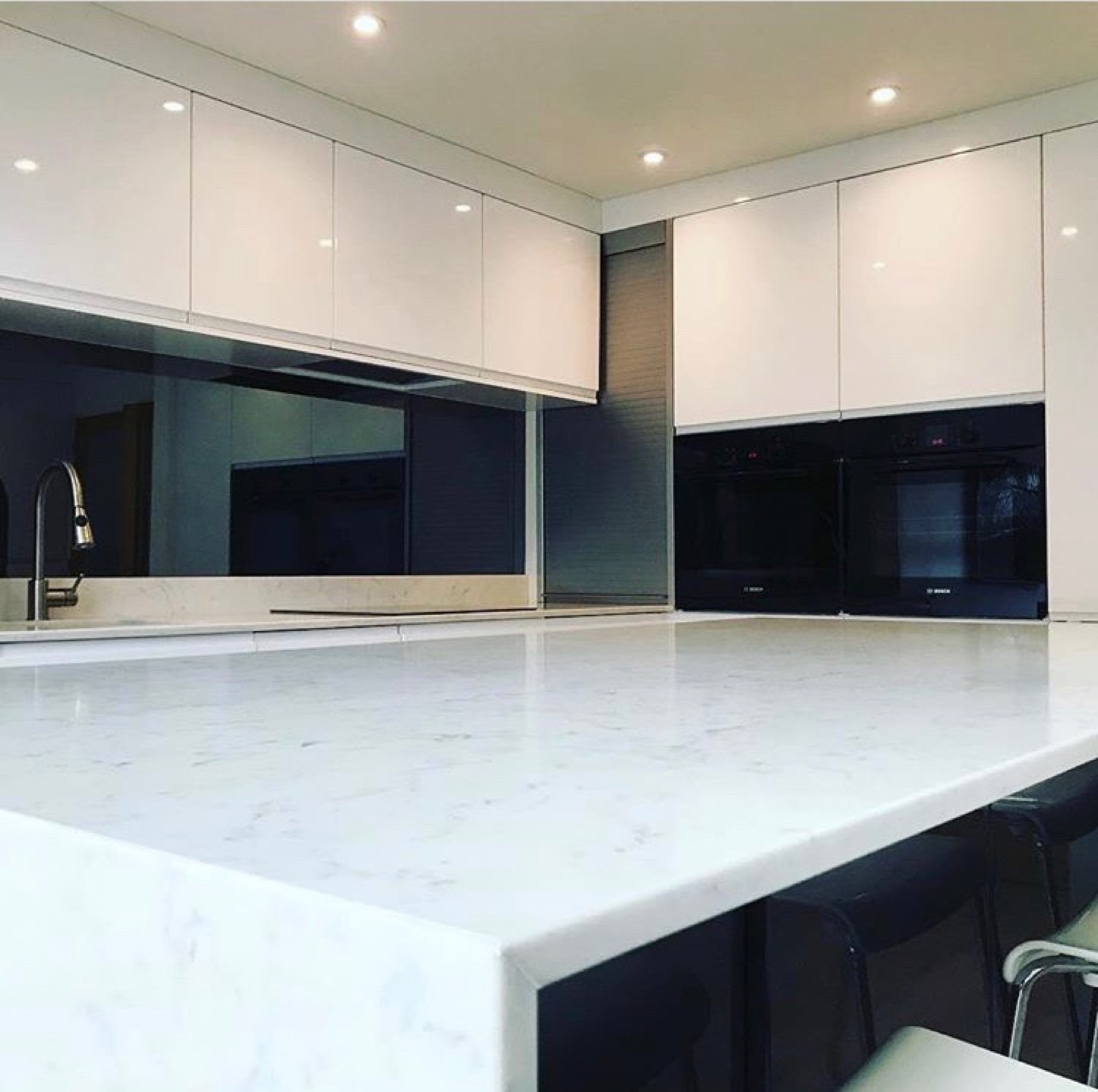 Kitchen white gloss black glass marble island close-up, made and fitted by Sussex Design Interiors
