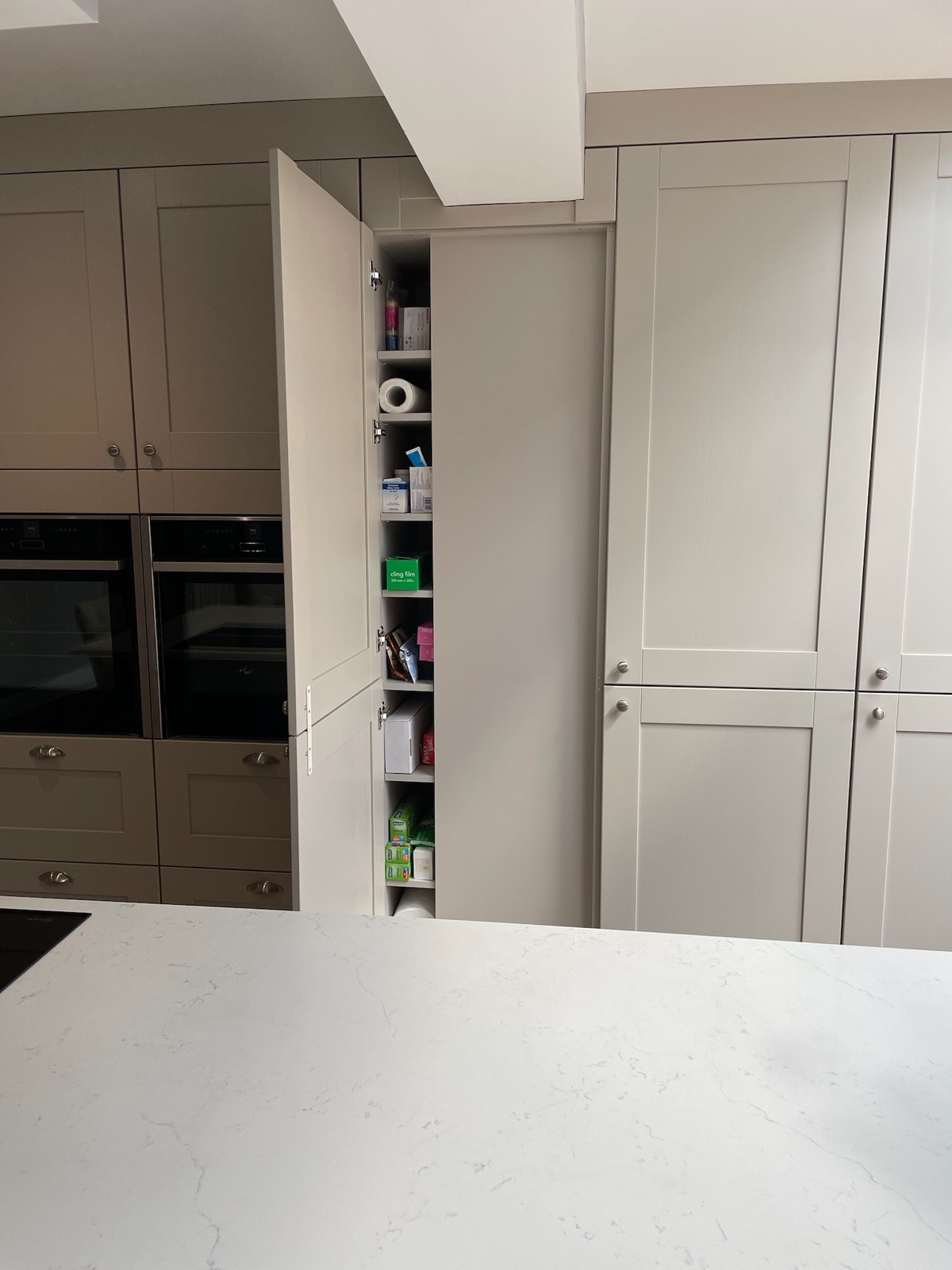 Pantry tall larder unit open door taupe, made and fitted by Sussex Design Interiors