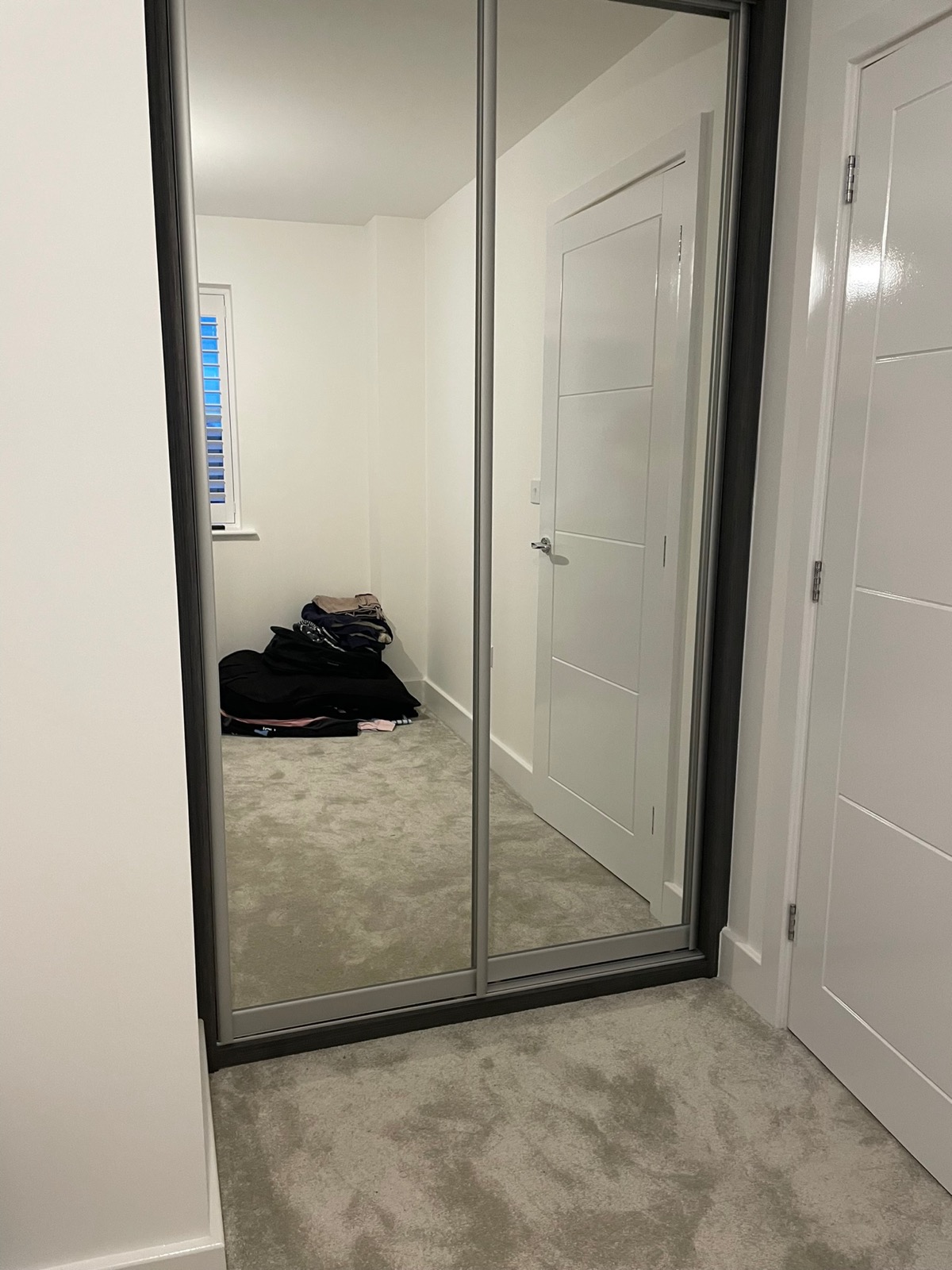 Wardrobe black frame mirror sliding door hallway, made and fitted by Sussex Design Interiors